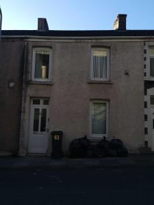 a building with a trash can in front of it at Bright and Modern 4 bed house- TV IN EVERY ROOM in Port Talbot