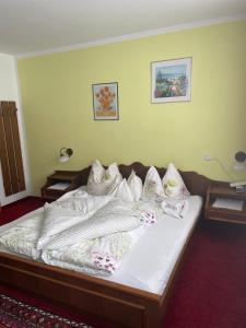 a bedroom with a bed with white sheets and pillows at Gästehaus Eberl - Rita in Finkenberg