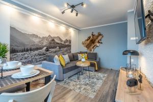 a living room with a couch and a table at Apartament Dworzec Tatrzański in Zakopane