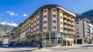 a large building on a street in a city at Roc Blanc Hotel & Spa in Andorra la Vella
