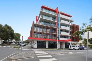 a large building with a red and white at Newly Refurnished Beachside 1-Bedroom Apartment in Melbourne