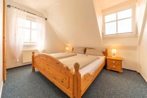 Postel nebo postele na pokoji v ubytování Ferienwohnung Lüttje Huck - Seeblick 1