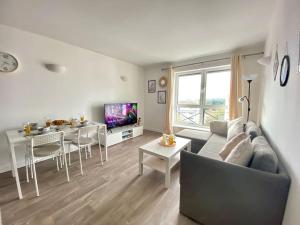 a living room with a couch and a dining room at City Centre Apartment Northampton in Northampton