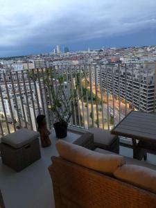un balcone con divano, tavoli e città di Stunning view over Vienna in City Center a Vienna
