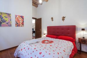 a bedroom with a large bed with a red headboard at Residenza Principe Amedeo City Center free parking in Verona