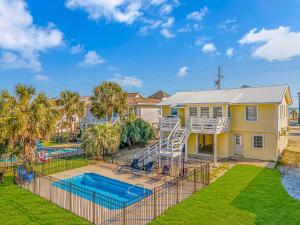 a house with a slide and a swimming pool at Pet Friendly Beach House! Private Dock On Channel! Private Pool! 5 bedroom - 3 bath! in Myrtle Beach