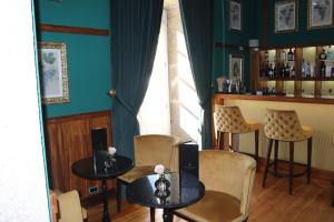 a restaurant with two tables and chairs and a bar at Solar do Requeijo by Luna Hotels & Resorts in Arcos de Valdevez