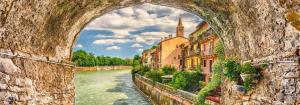a view of a river through a stone bridge at Residenza Principe Amedeo City Center free parking in Verona