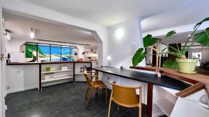 a kitchen with chairs and a counter with a table at Coliving Napoléon III in Ajaccio