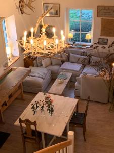 a living room with a couch and a table with candles at Landhaus „Blattgold“ in Lohme