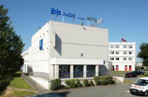 a white building with a sign on the top of it at ibis budget Poitiers Sud in Poitiers