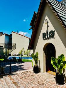 a building with a sign on the side of it at RIO TIGRE HOTEL in Tigre