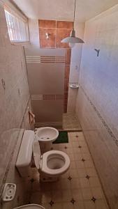 a small bathroom with a toilet and a sink at Departamento Rivadavia in Guaymallen +13 photos