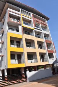an apartment building with yellow and white at VENUS HOMES in Mangalore