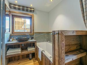 a bathroom with a wooden tub and a sink at Appartement Val-d'Isère, 4 pièces, 6 personnes - FR-1-694-155 in Val-d'Isère