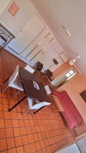 a room with a table and a bed in it at Departamento Rivadavia in Guaymallen