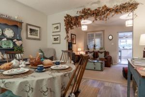 a kitchen and living room with a table and chairs at Leatside Cottage in Dulverton