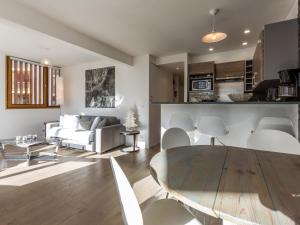 a living room with a couch and a table at Appartement élégant contemporain avec balcon sud et wifi - FR-1-694-170 in Val dʼIsère +9 photos