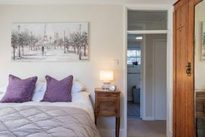 a bedroom with a bed and a picture on the wall at Leatside Cottage in Dulverton