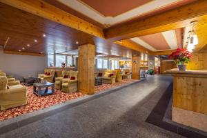 a lobby of a hotel with couches and chairs at Hotel Piandineve in Passo del Tonale