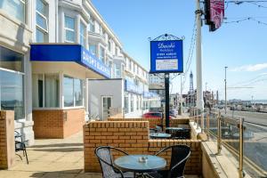 a sidewalk with a table and chairs on a street at Daish's Blackpool Hotel in Blackpool