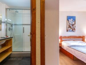 a bathroom with a shower and a bed in a room at Appartement Val-d'Isère, 4 pièces, 8 personnes - FR-1-694-208 in Val-d'Isère
