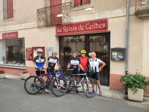 a group of people standing with their bikes in front of a store at Le Relais de Ceilhes in Ceilhes-et-Rocozels