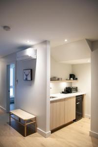 a kitchen with a stove and a table in it at Suites du Lac Moore in Mont-Tremblant