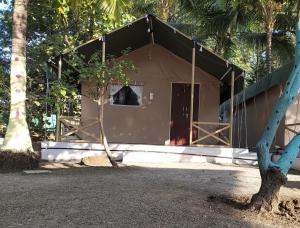 a small building with a door in front of it at shree farm in Alibaug