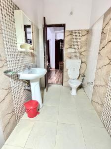 a bathroom with a toilet and a sink at Vanshika homes Near mall road in Kasauli