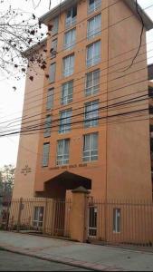 a tall building with a fence in front of it at Departamento Amoblado y equipado. in Talca