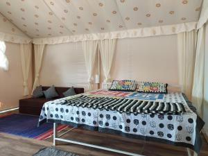 a bedroom with a large bed with a couch at shree farm in Alibaug