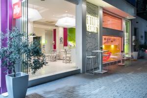 a store window with tables and chairs inside of it at Afrodite Suites in Potos