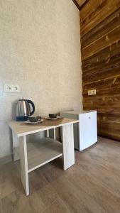 a table with two bowls on it next to a refrigerator at Harsnadzor Eco Resort in Halidzor