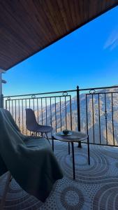 a room with a balcony with a table and a chair at Harsnadzor Eco Resort in Halidzor