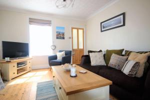a living room with a couch and a table at Tides Reach in Walmer