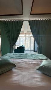 a large bed with green drapes in a bedroom at Harsnadzor Eco Resort in Halidzor