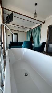 a white bath tub in a living room with chairs at Harsnadzor Eco Resort in Halidzor