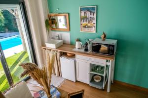 a kitchen with a counter with a microwave on it at Suites by Aix Keys avec jacuzzi privatif 5 min des plages Fouras in Saint-Laurent-de-la-Prée