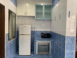 a kitchen with a refrigerator and a stove at Home in Nilai in Nilai