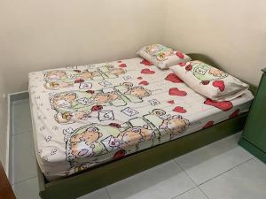 a bed with hello kitty sheets and pillows on it at Home in Nilai in Nilai
