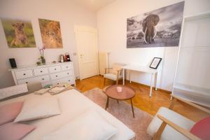 a living room with a white couch and a table at Room Eight - Your Space in the City in Lugano