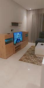 a living room with a flat screen tv on a wooden entertainment center at Luxury Studio Princess in Casablanca