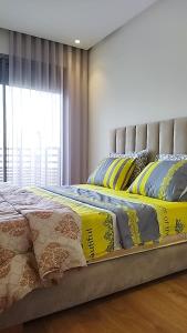 a bedroom with a bed with yellow and blue comforter at Luxury Studio Princess in Casablanca
