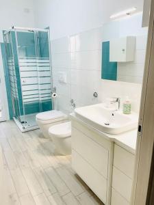 a bathroom with a toilet and a sink and a shower at Emme Apartment IUN (Q8410) in Cagliari