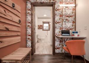 a room with a desk and a corridor with a bathroom at The Harbor Hotel Chic, Retro Hotel in Prescott
