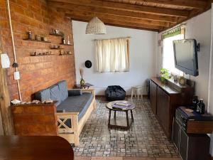 a living room with a couch and a tv at Evergreen in Mar del Plata