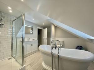 a bathroom with a bath tub and a staircase at Malvern House in Deal