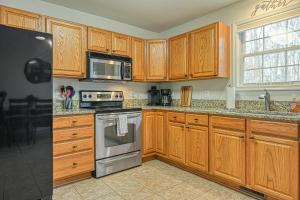 a kitchen with wooden cabinets and stainless steel appliances at Sunny Side Up in Mineral
