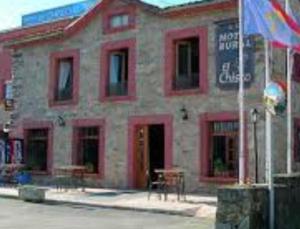 a building with a flag in front of it at Casa Chisco in Cudillero